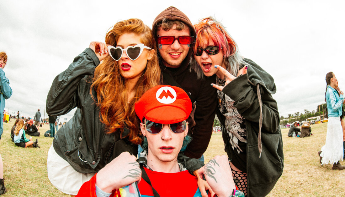 4 fans pose for photo wearing various types of sunglasses at Leeds Festival