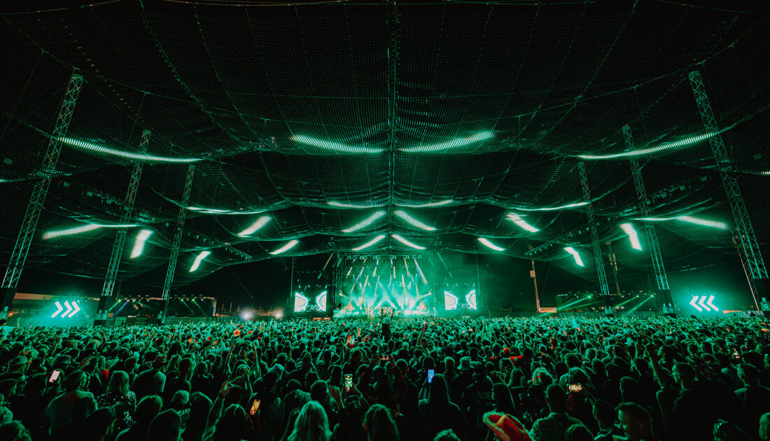 Fans under the green LED lights of the Chevron Stage at Leeds Festival