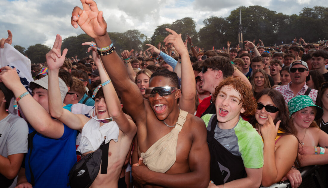 excited fans cheering in crowd at Leeds Festival 