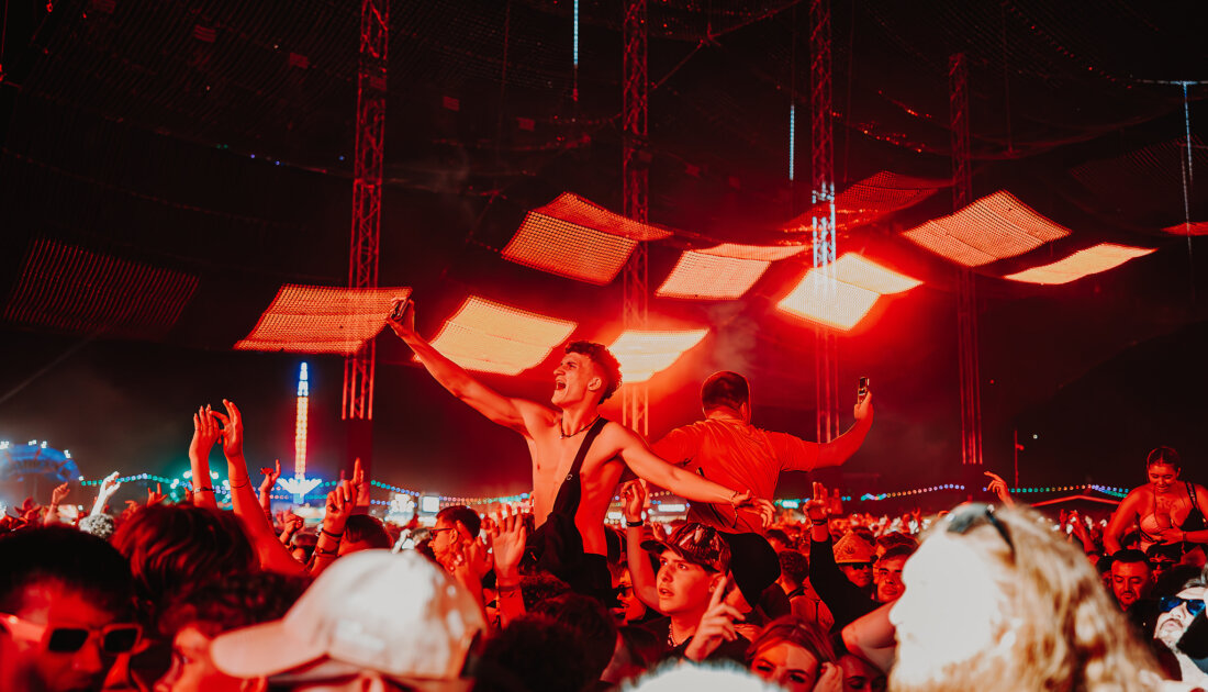 A fan on friends shoulders at Reading Festival 
