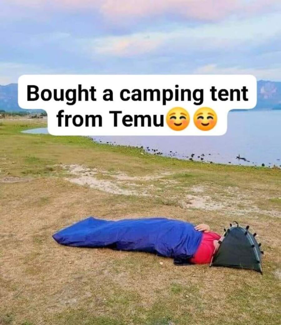 An image of someone outside in a sleeping bag with a tiny tent covering their face