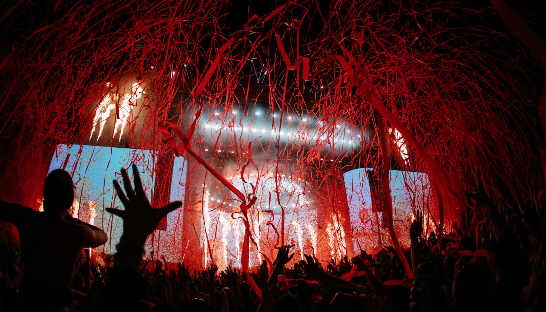 Red streams of confetti falling on crowd of fans during bring me the horizon performance at Leeds Festival 